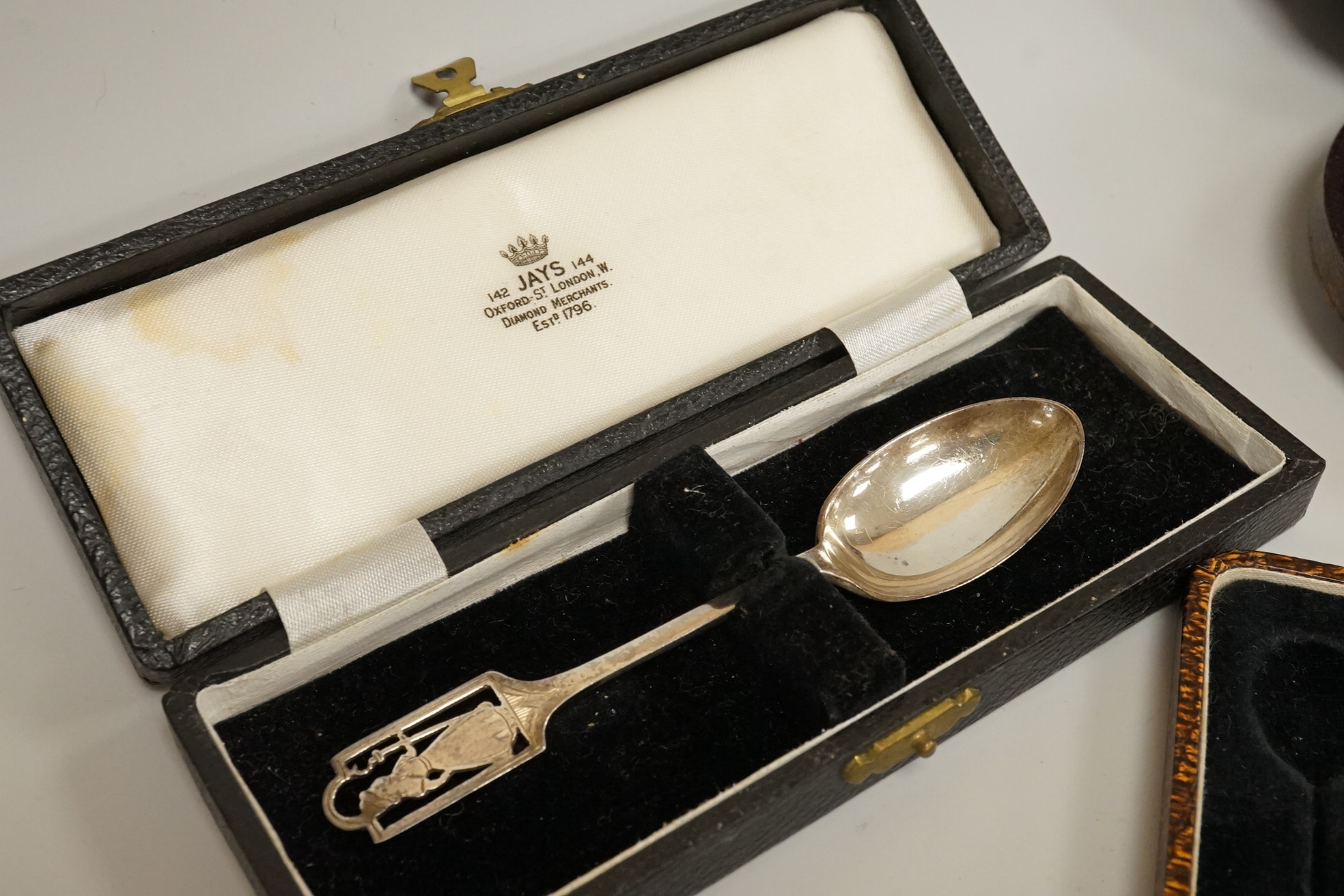 A cased pair of Victorian silver circular salts, by Edward Hutton, London, 1886, lacking spoons, together with a cased set of six silver bean end coffee spoons, a cased silver spoon, a small silver 'Dunlop Golf Ball Hole